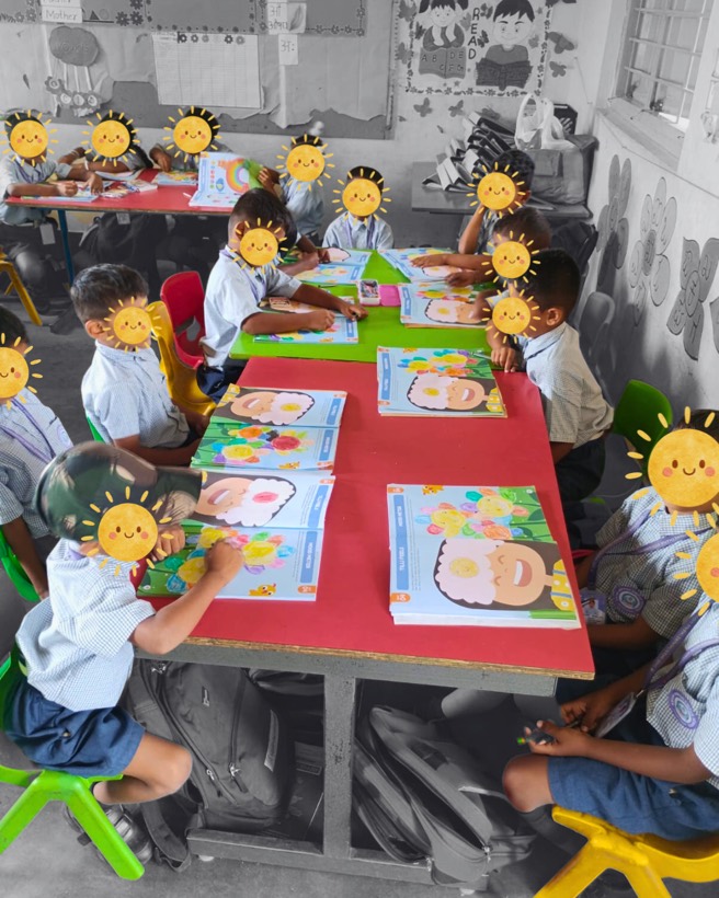 Children working through Tilli activity books in a classroom