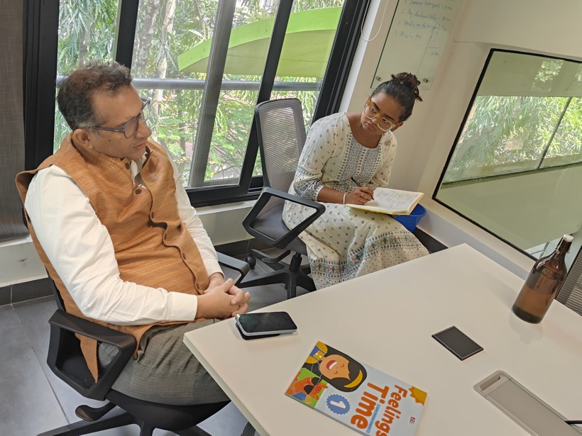 A Tilli team member taking notes in a meeting with a school leader