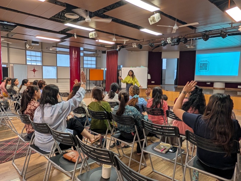 Teachers raising their hands at a Tilli training workshop